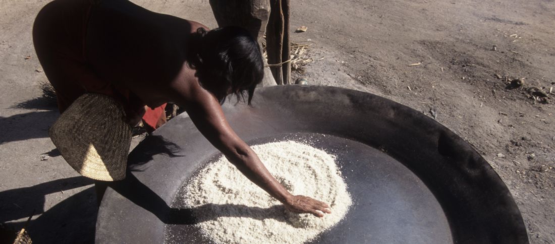 Índia preparando farinha na Amazônia